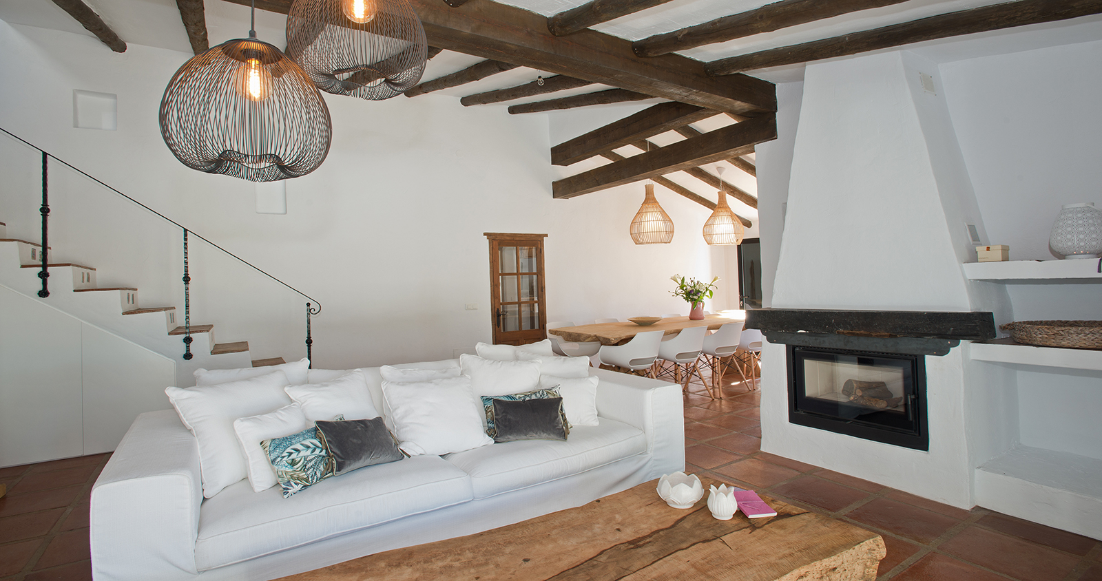 Lichte woonkamer met houten balken en open haard